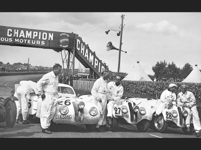 The victorious NSKK team with their cars after the 1939 24 Hours of Le Mans race. From left to right: Hans Wencher, Ralph Roese, Paul Heinemann, Willi Briem, and Rudolf Scholz.