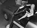 Actress and model Barbara Roscoe poses behind the wheel of the new DB5 convertible at the Earls Court Motor Show, London, October 15, 1963.