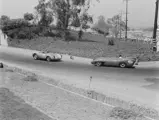 Richie Ginther in chassis no. 550-0089, race #211, leads John Timanus in a Lotus Mark VIII, race #41, through a turn at the 1956 Pomono Road Races.