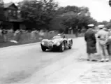 Phil Hill and XKC 007 race towards the very first victory for the C-Type in America at Elkhart Lake.