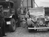 Prince Bernhard waits with the Bentley as Princess Juliana returns from Canada to the liberated Netherlands in August 1945.
