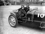 Lady Cholmondeley and Malcolm Campbell pose for a photo in chassis number 4394 at Brooklands.