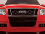 Ford Sport Trac Adrenalin teaser: Adrenalin's aggressive fascia features a "black chrome" grille surround with matching headlight bezels.