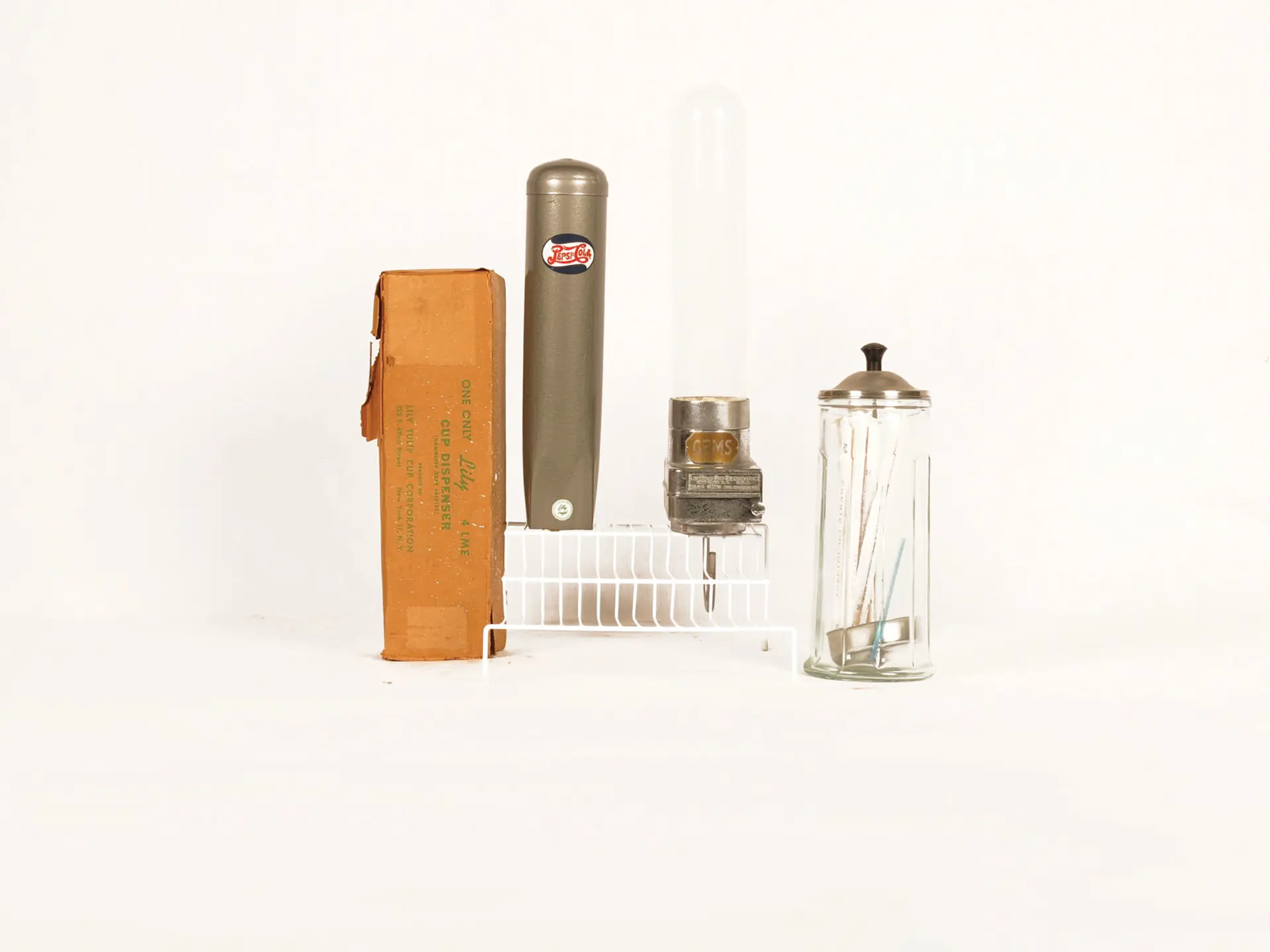 PepsiCola and Gems Cup Dispensers Together with a Soda Fountain Straw