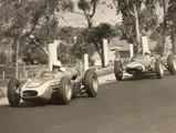 Chuck Daigh, in the #5 Scarab, leads the #7 Lotus of Stirling Moss at the 1962 Sandown International Cup, Melbourne, Australia.