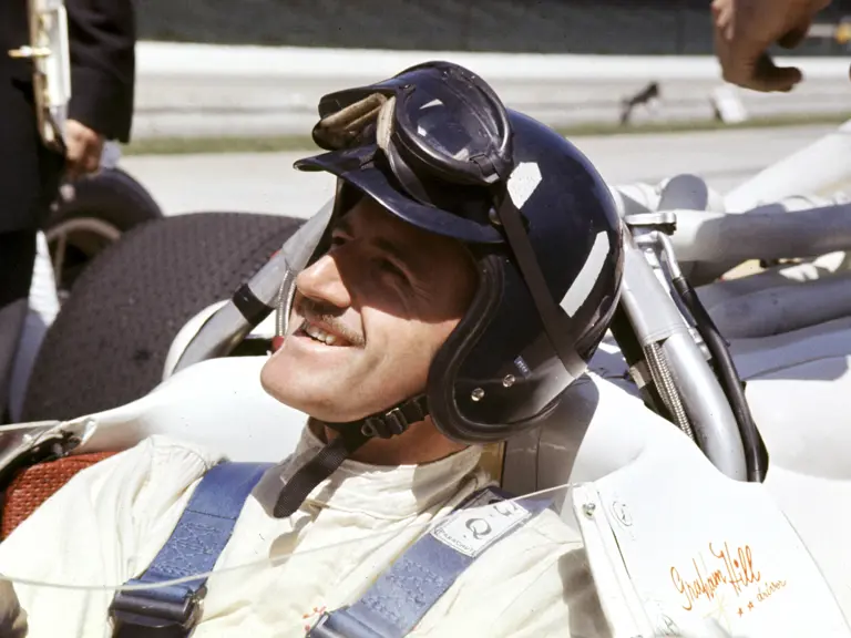 Graham Hill wearing the very helmet on offer at the 1966 Indianapolis 500 which he won.