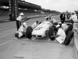 Eddie gets a set of fresh tires, some quick advice, and a cold drink during a pit stop at the 1960 Indianapolis 500.