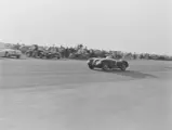 Phil Hill racing XKC 007 in late 1952, believed to be at Madera Airport in California.