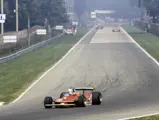 Scheckter leads the pack as he rounds the end of the main straight at Monza Circuit at the 1979 Italian Grand Prix, where the Ferrari driver finished in 1st place.