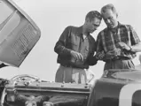 Phil Hill and a friend confer over XKC 007 in California in 1952.