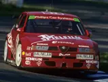 The Alfa Romeo 155 TI touring car tackles the kerbs at the Hockenheimring during the 1994 DTM season.