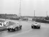 Chassis 1147, the Factory-entered OSCA MT4 driven by Lance Macklin and Pierre Leygonie, takes the inside line against the Ferrari 375 Plus of Maurice Trintignant and José Froilán González during the 1954 24 Hours of Le Mans.