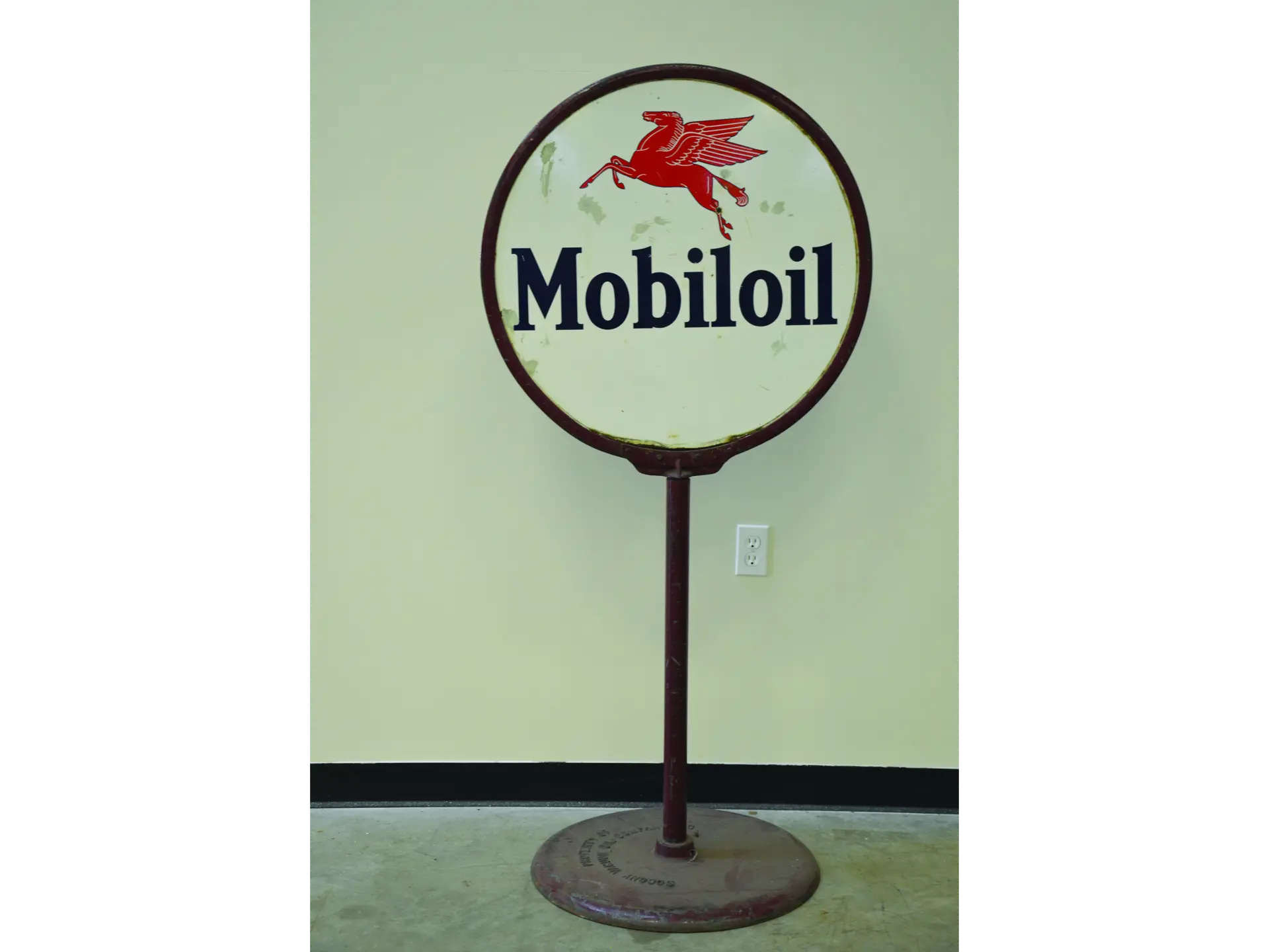 A doublesided, porcelain ‘Mobiloil,’ “lollipop” curb sign, 63" height