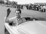 Menditeguy waving as he pulls up to the start finish line after finishing first at Playa Grande circuit in chassis 0024 on 15 January 1950.