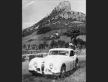 The Talbot-Lago is pictured at a rally, believed to be around 1954. The cliff in the background is La Roche de Solutré, not far from Mâcon, France.