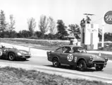 The Sunbeam Harrington Alpine NART leads a Ferrari 268 SP out of a corner at the 1963 12 Hours of Sebring.