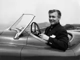 Clark Gable looks delighted with his new Jaguar, pictured having just taken delivery of “MDU 420”.