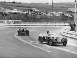 Hugh Gearing and his beloved 6C 1750 outpaces a Bugatti at an event at Kyalami, ca. 1970s.