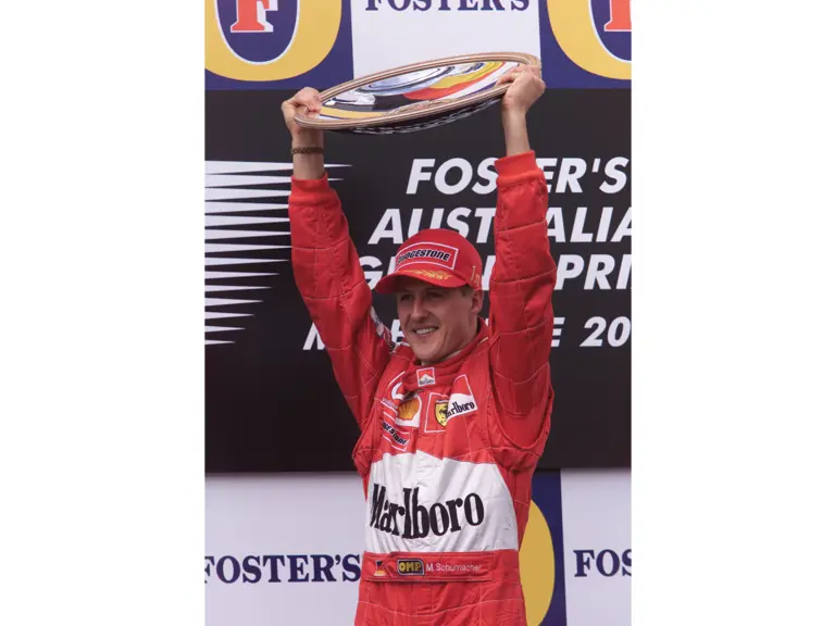 Michael Scumacher holds aloft the winner’s trophy after finishing 1st at the 2002 Austrialian Grand Prix.