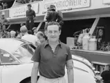 Briggs Cunningham takes a moment to pose in front of one of his three Corvettes before the race begins.