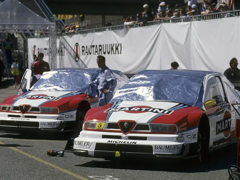 Nicola Larini (5) and Alessandro Nannini (6) relax with their Alfa Romeo 155 V6 Ti's before the 1996
Helsinki race.