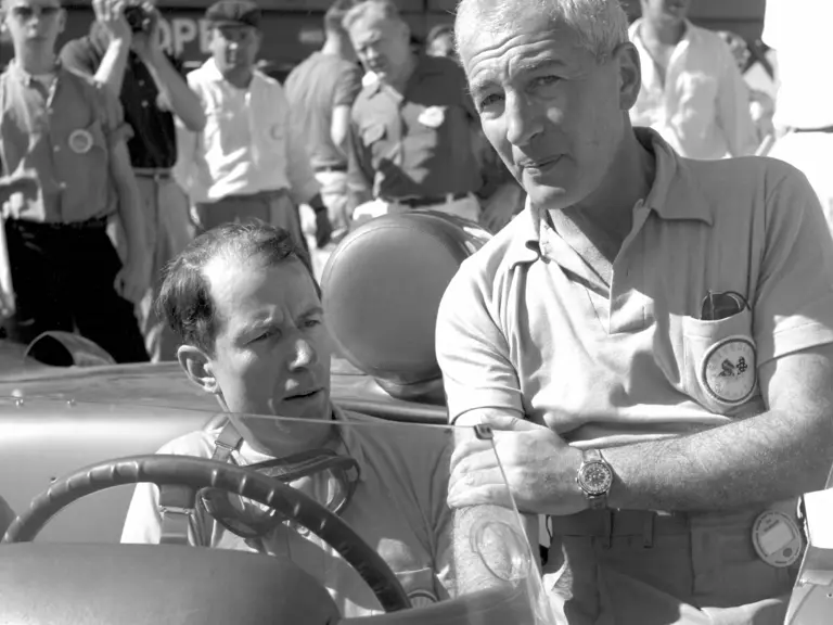 Zora Arkus-Duntov talks to driver John Fitch, seated in the Corvette SS, leading up to the start of the 1957 12 Hours of Sebring.