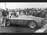Carlos Menditeguy posing for a photograph with chassis 0024, following his victory at the Playa Grande circuit in Argentina on 15 January 1950.