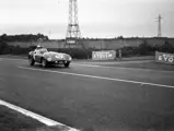 Driver’s eyes lock with camera in the opening stages of the 1955 24 Hours of Le Mans.