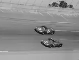 6053 (Car no. 24) co-driven by Innes Ireland, Mike Hailwood, and George Drummond battles Car no. 22, another Ferrari 250 LM, co-driven by Jochen Rindt and Bob Bondurant at the 24 Hours of Daytona, 1966.